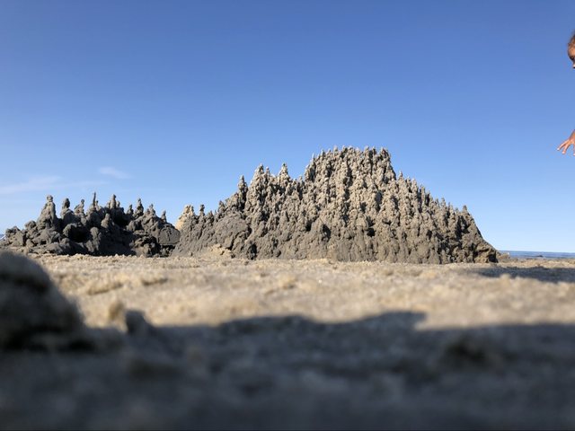 Expansive sand sculpture formed from hundreds of narrow spires