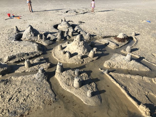 Star-shaped sandcastle complex with towers and water channels